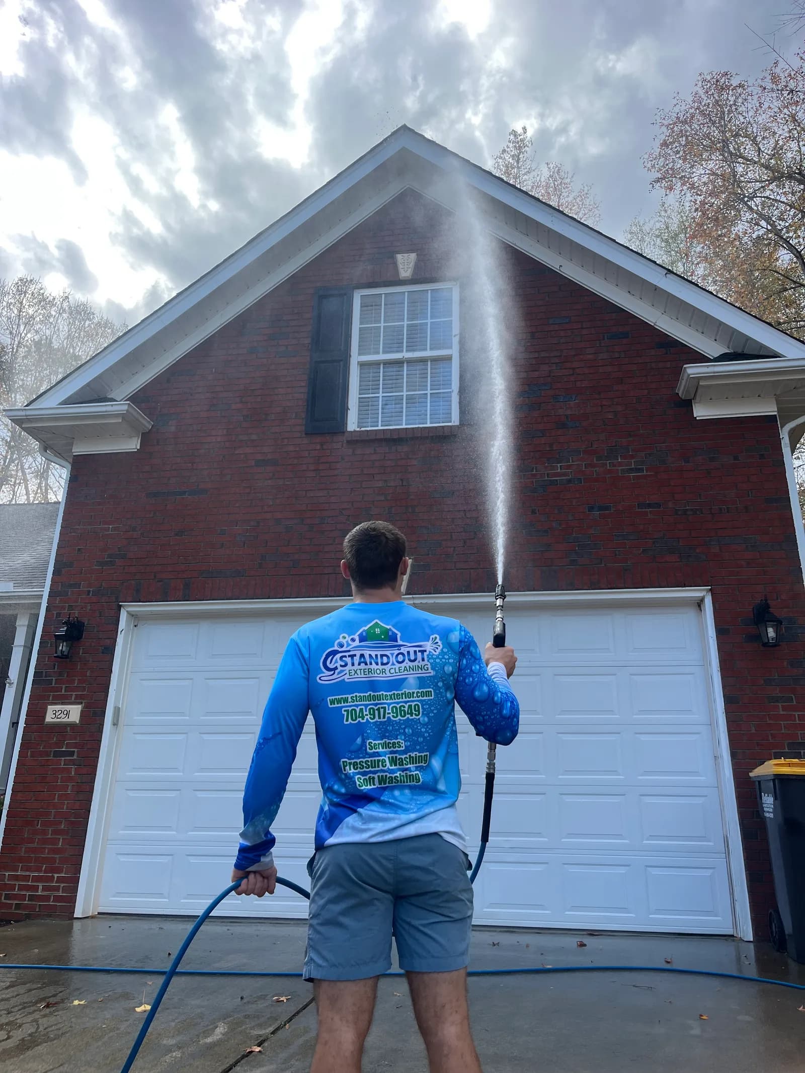 Ridge Curwood soft washing a brick home in Denver NC
